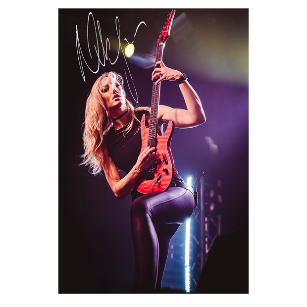 8x10 signed print featuring Nita Strauss playing a red guitar on stage